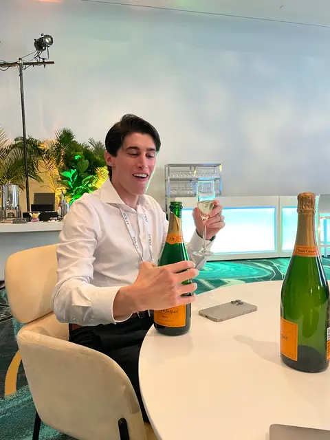 Fluffy with two bottles of Champagne